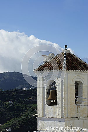 Charming old church, Frigiliana village, Spain. Close up view of bell tower. Stock Photo