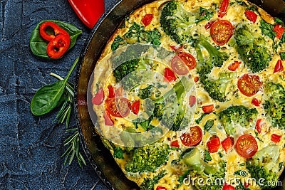 Frittata with broccoli in a frying pan. Stock Photo