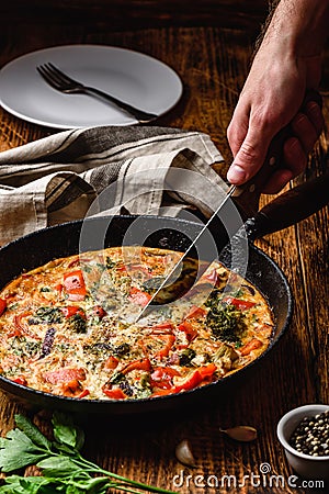 Frittata with broccoli, red bell pepper and red onion Stock Photo