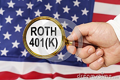 In front of the American flag, a man holds a magnifying glass in his hand with the inscription - Roth 401k Stock Photo