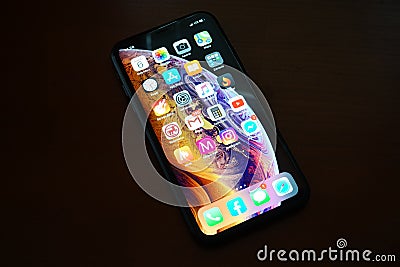 Front of a black iPhone XR on a wooden table Editorial Stock Photo