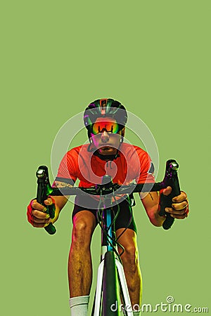 Front camera view of sportsman, cyclist on bicycle in red sports uniform and protective helmet isolated on green Stock Photo