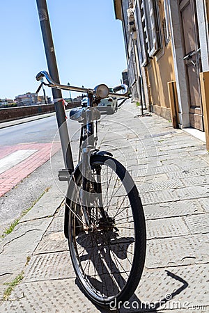 front of city bike which is secured to the sign on the street Stock Photo