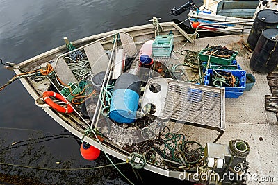 Front deck of a small professional fishing trawler in a harbor. Separation table, empty crates, lines, different shape and color Stock Photo