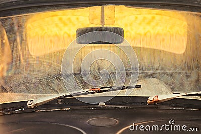 Front of a dirty old car with rusted screen wipers Stock Photo