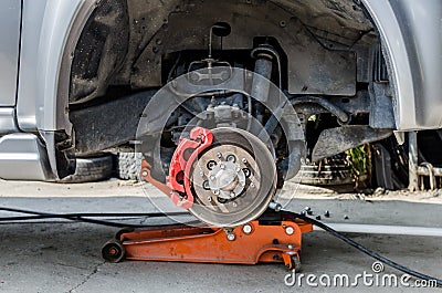 Front disc brake on car in process of new tyre replacement. Stock Photo