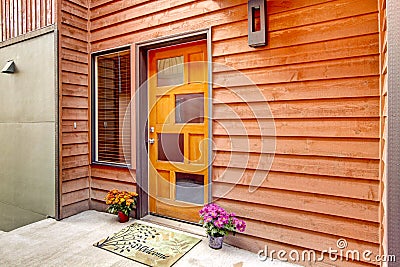 Front door with open porch and flower pots Stock Photo