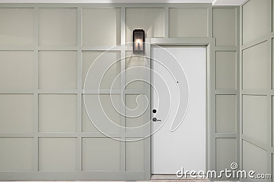 A front door surrounded by sage green wainscoting. Stock Photo