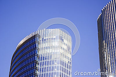Front faÃ§ade of a blue corporate building next to its twin building. Stock Photo