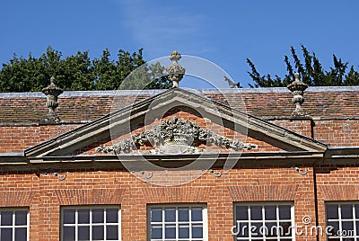 Front gable with sculptured pediment and urns Stock Photo