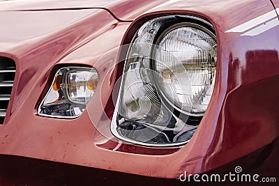 front headlight is a close-up of an old powerful classic American car Stock Photo