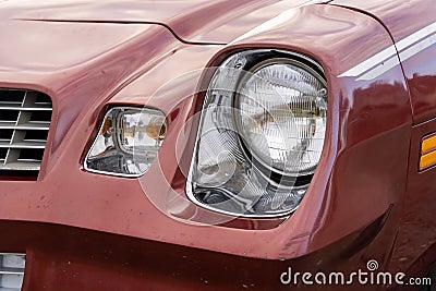 front headlight is a close-up of an old powerful classic American car Stock Photo