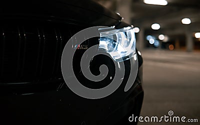 Front light of an Incredibly amazing jaw dropping metallic black BMW M3 CS m power sports car Editorial Stock Photo