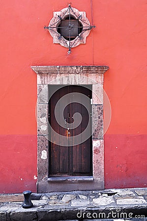 Front of an old mexican house - Colonial style door and window Stock Photo