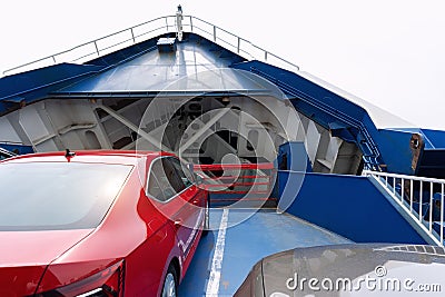 Front open door of passenger freight cargo ferry boat vessel ship with loaded cars and vehicles. Sea transportation Stock Photo