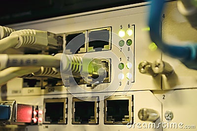 Front panel of an old internet switch. Network interfaces and cables are interconnected. Communication wires connect to equipment Stock Photo