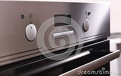 Front Panel Of The Oven.Round knob on a silver electric oven close up. background of an electric oven close up Stock Photo