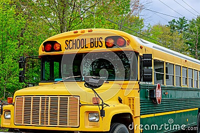 Front part of yellow school bus children educational transport with signs in the parking Stock Photo