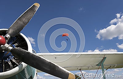 Plane and landing parachutists Stock Photo