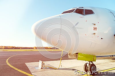 Front profile and cockpit windows of wide-body airplane. Stock Photo