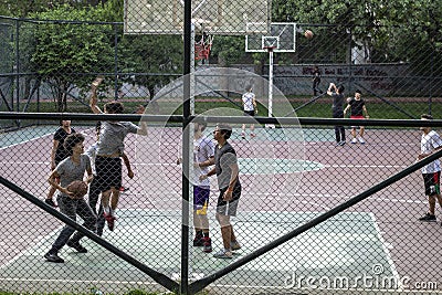 Front shoot of children playing basketball on the street hall Editorial Stock Photo