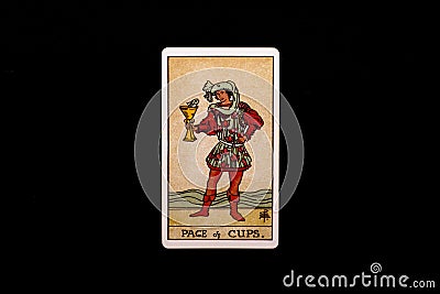 An individual minor arcana tarot card isolated on black background. Page of cups. Stock Photo