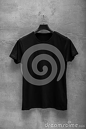 Front side of male black cotton t-shirt on a hanger Stock Photo