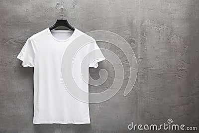 Front side of male white cotton t-shirt on a hanger Stock Photo