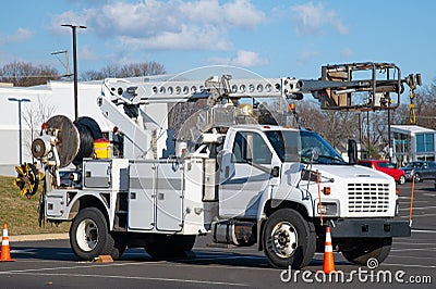Front and side view of parked communication utility trucks in residential neighborhood Stock Photo