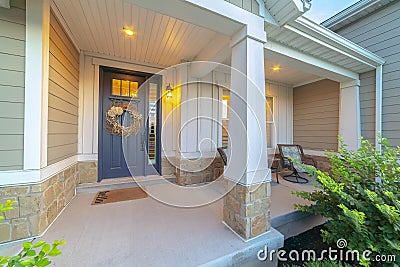 Front and sidelight of home with front porch and wood siding exetrior wall Stock Photo