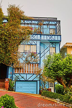 Front of stunning blue west coast home on Lombard Street's red brick road Editorial Stock Photo