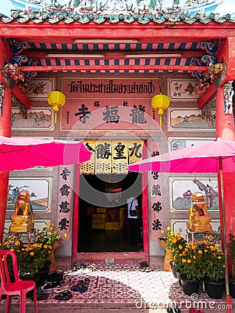 Front of Thai Chinese temple.Thai and Chinese language in image is name of temple and quotes about life. Editorial Stock Photo