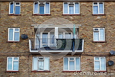 the front of a typical English council flat block with balconies and washing lines Stock Photo