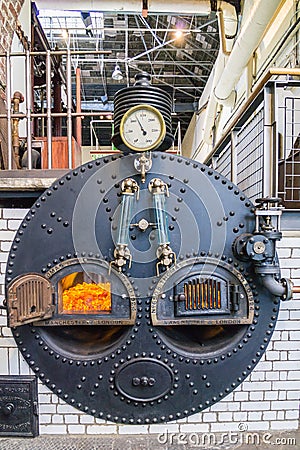 Front view of ancient steam boiler with pressure gauge and fittings Stock Photo