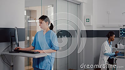 Front view of assistant typing medical expertise on computer Stock Photo