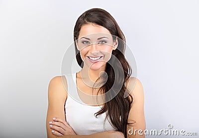Front view of beautiful woman with nude makeup and healthy shine skin looking with folded arms Stock Photo
