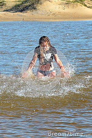 Teen girl splashing in water Stock Photo