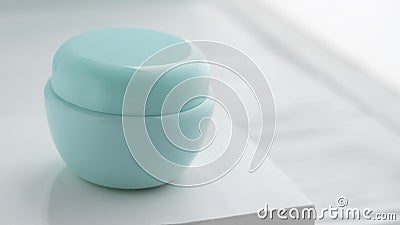Front view of blue lotion container on white box with copy space Stock Photo