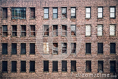 Front view of a boarded-up abandoned brick skyscraper building windows from the street in New York City Stock Photo