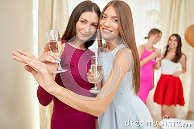 Bride showing engagement ring to friend. Stock Photo