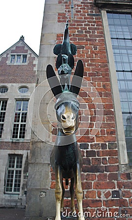 Front view of bronze statue of the Town Musicians of Bremen in old city centre, beautiful houses on the background, Bremen, Editorial Stock Photo