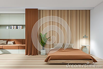 Front view on brown bedroom interior with bed, sofa, bedside Stock Photo