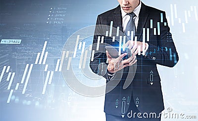 Front view of businessman with tablet in hands trades on stock m Stock Photo