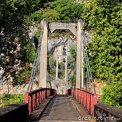 Front view of the carriageway of a bridge and cliffs and forest in the background. Stock Photo