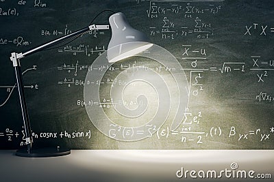 Front view on chalkboard with mathematical formulas background with place for product presentation illuminated by white table lamp Stock Photo