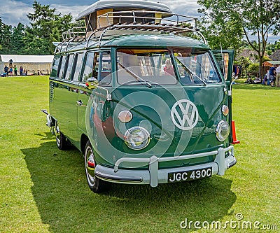 Isolated classic and vintage VW camper van in a green field Editorial Stock Photo