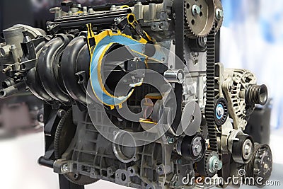 Front view on clean car engine toothed belt, pulley, electric equipment, engine components. Engine with cross section. Close up ca Stock Photo