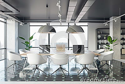 Front view of a comfortable workplaces in a modern open loft office interior with desks, computers, and a window. Modern workspace Stock Photo