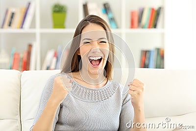 Front view of an excited woman looking at camera at home Stock Photo