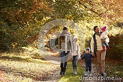 Front View Of Family Enjoying Autumn Walk In Countryside Stock Photo